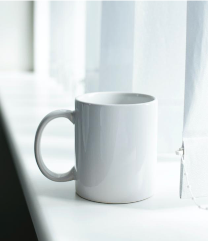 Image of a white mug sitting in front of a window. Representing the customization of dating coaching in Oregon. You can get support from a dating coach in Salem, OR. 