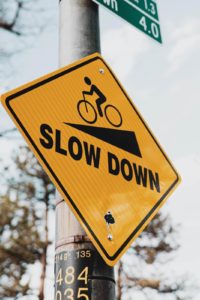 Image of a sign saying "slow down". Showing one of the techniques taught by a dating coach in Salem, OR. No matter where you are in Oregon dating coaching can help you find a meaningful relationship.